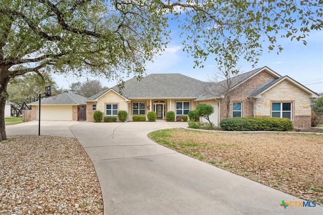 single story home featuring concrete driveway and brick siding