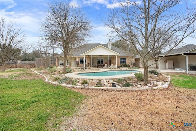 view of pool with a fenced in pool, a patio, a lawn, and fence