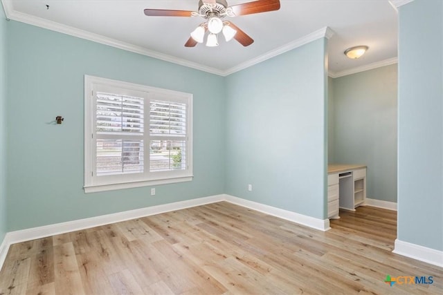 unfurnished room with light wood-type flooring, crown molding, and baseboards