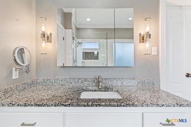 bathroom featuring recessed lighting and vanity