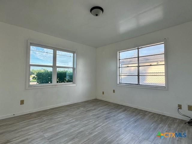 2009 S Laurent St, Victoria, TX 77901 - unfurnished room featuring plenty of natural light and wood finished floors