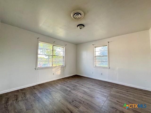 2009 S Laurent St, Victoria, TX 77901 - unfurnished room with dark wood-type flooring and plenty of natural light