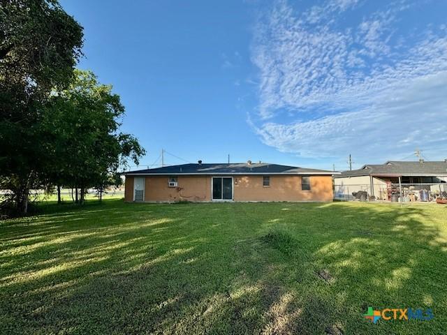 2009 S Laurent St, Victoria, TX 77901 - rear view of property with a lawn