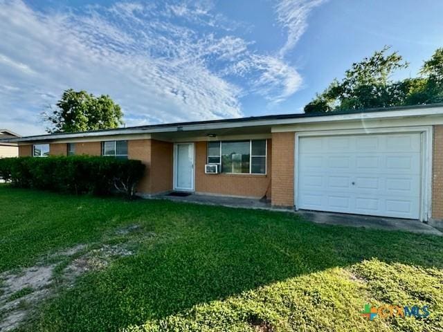 2009 S Laurent St, Victoria, TX 77901 - single story home with an attached garage, a front lawn, brick siding, and driveway
