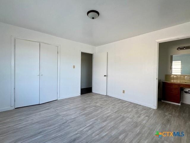 2009 S Laurent St, Victoria, TX 77901 - unfurnished bedroom featuring wood finished floors and a closet