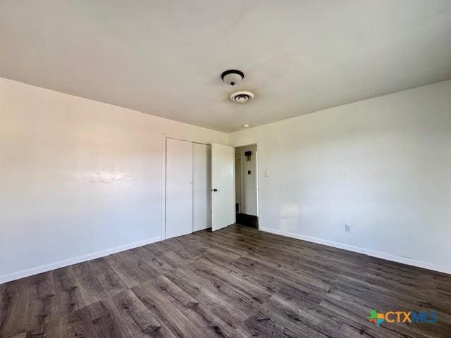 2009 S Laurent St, Victoria, TX 77901 - unfurnished room featuring dark wood-style flooring and baseboards