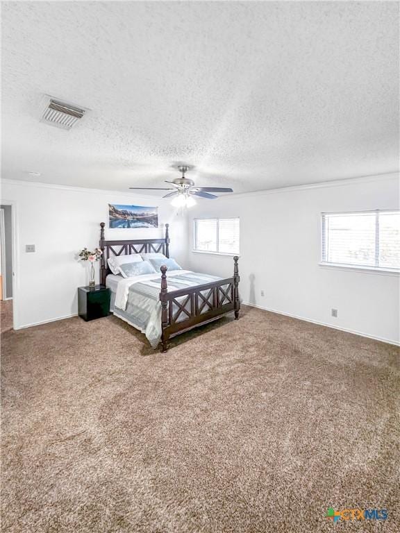 bedroom with carpet floors, visible vents, ceiling fan, a textured ceiling, and baseboards