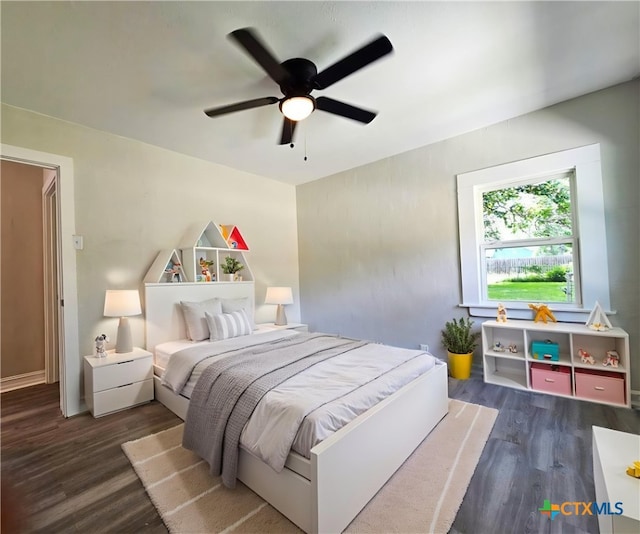 958 E Humphreys St, Seguin, TX 78155 - bedroom featuring dark wood finished floors and ceiling fan