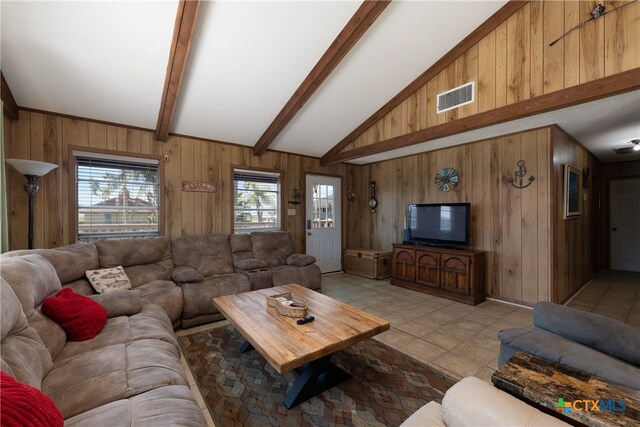 tiled living room with wooden walls and vaulted ceiling with beams