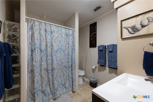 bathroom featuring vanity, toilet, and crown molding