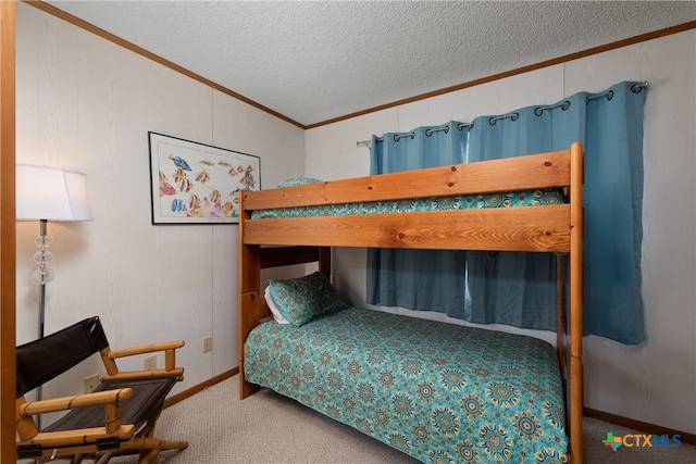 bedroom with carpet flooring, a textured ceiling, and crown molding