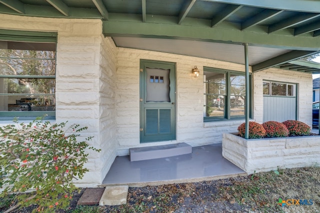 view of exterior entry featuring a porch