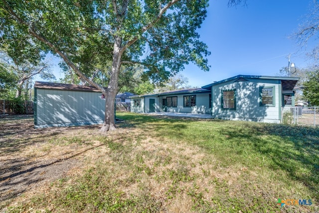 back of property featuring a patio and a yard