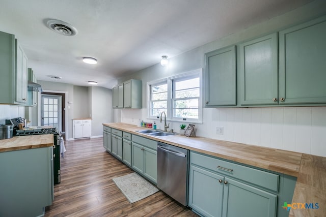 kitchen with wooden counters, gas range, sink, stainless steel dishwasher, and dark hardwood / wood-style floors