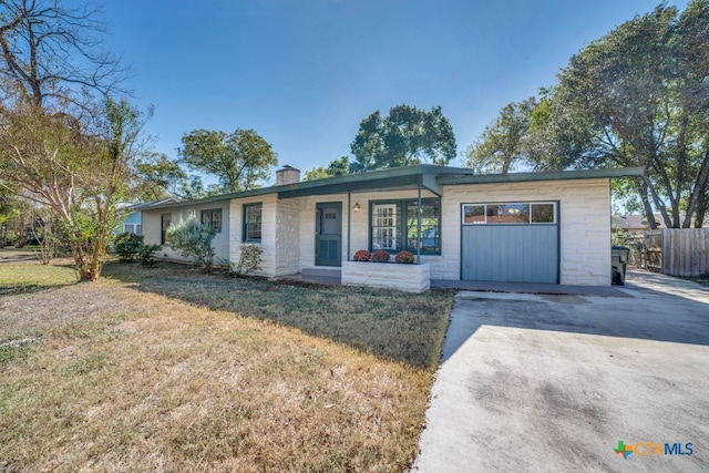 ranch-style house with a garage, a porch, and a front yard