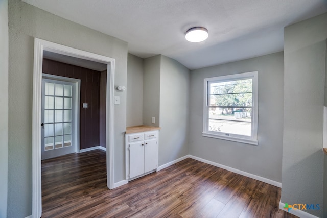 unfurnished room with dark hardwood / wood-style floors