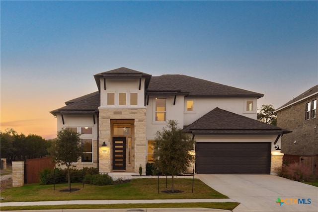 view of front of house with a yard and a garage