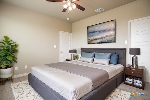 bedroom with light carpet and ceiling fan