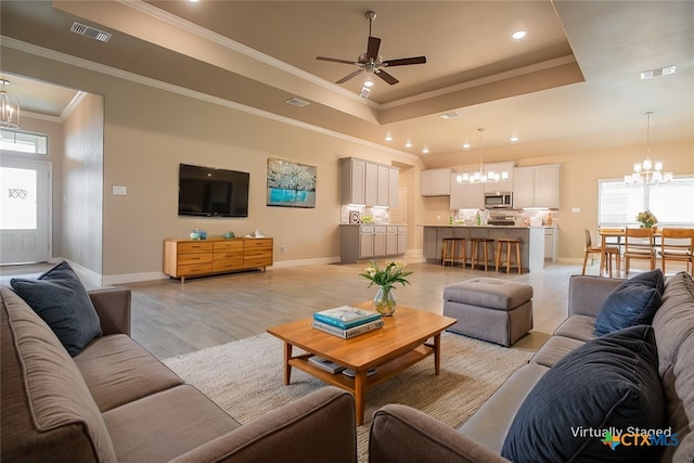 1018 Winchester Dr, Nolanville, TX 76559 - living area featuring a chandelier, a tray ceiling, baseboards, recessed lighting, and crown molding