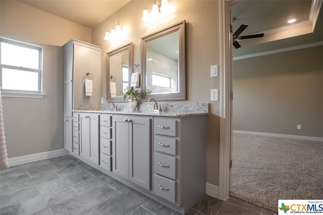 bathroom featuring ornamental molding, vanity, and ceiling fan