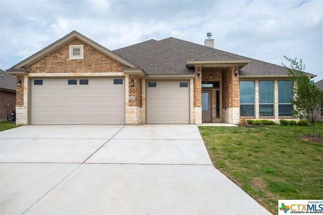 1018 Winchester Dr, Nolanville, TX 76559 - view of front of property with an attached garage, a front yard, concrete driveway, roof with shingles, and a chimney