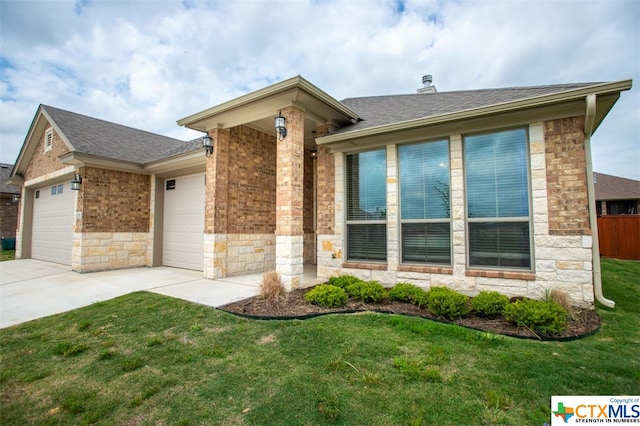 view of front of property with a garage and a front yard