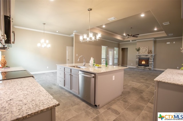 kitchen with sink, stainless steel dishwasher, decorative light fixtures, and a kitchen island with sink