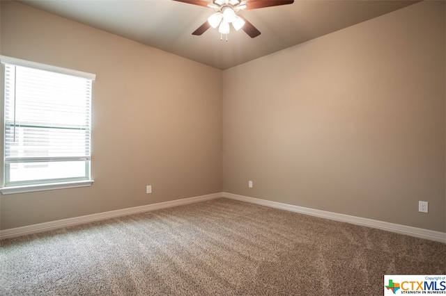 carpeted spare room with ceiling fan