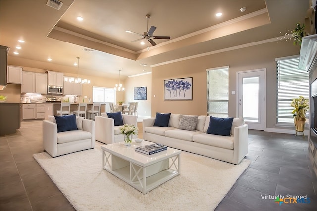 1018 Winchester Dr, Nolanville, TX 76559 - living area featuring a raised ceiling, a ceiling fan, a chandelier, recessed lighting, and ornamental molding