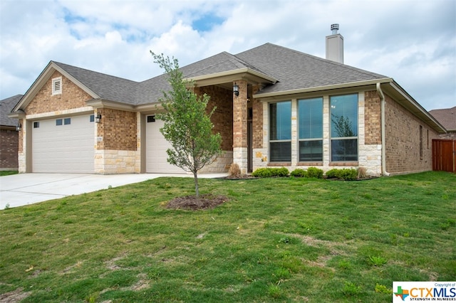 view of front of home featuring a garage and a front yard