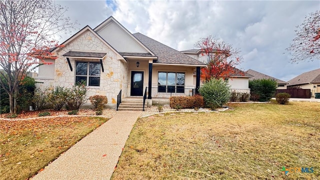 view of front of house featuring covered porch and a front lawn