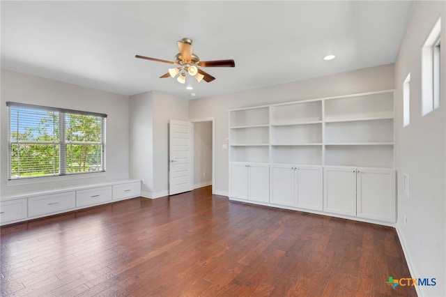 unfurnished bedroom with ceiling fan and dark hardwood / wood-style floors