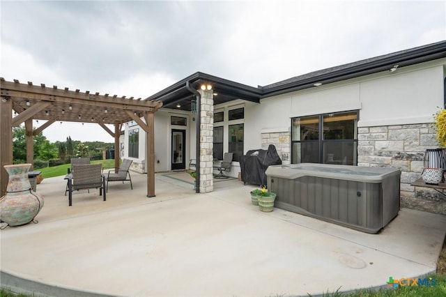 view of patio / terrace featuring a pergola and a hot tub