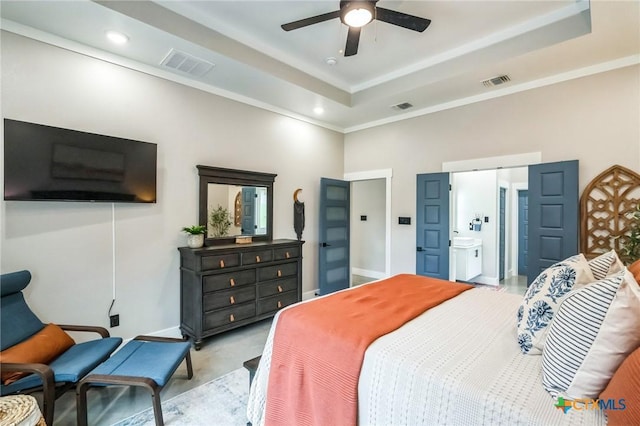 bedroom featuring visible vents, ornamental molding, and a tray ceiling