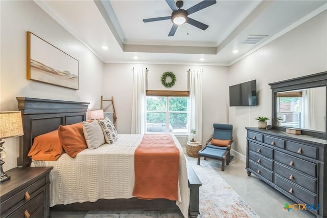 bedroom featuring crown molding, ceiling fan, a raised ceiling, baseboards, and visible vents