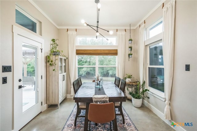 interior space with crown molding, baseboards, a notable chandelier, and finished concrete floors
