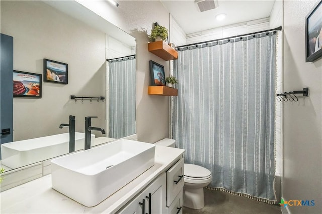 bathroom with visible vents, curtained shower, toilet, and vanity