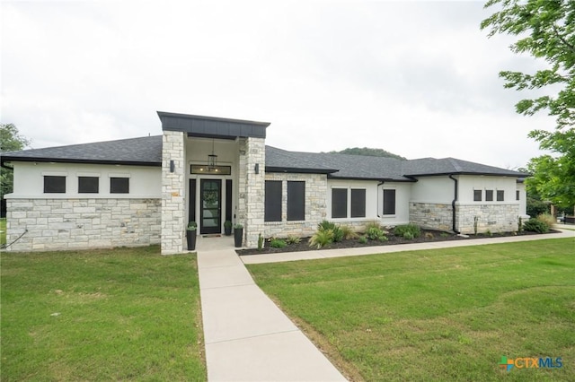 prairie-style house with stucco siding, a front lawn, and stone siding
