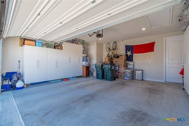 garage featuring a garage door opener and recessed lighting