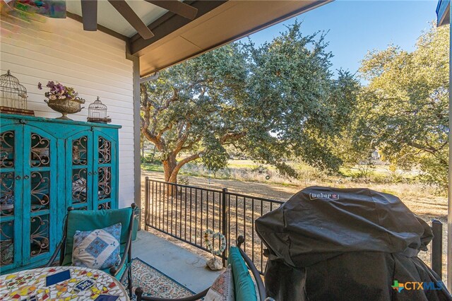 balcony with ceiling fan and a grill