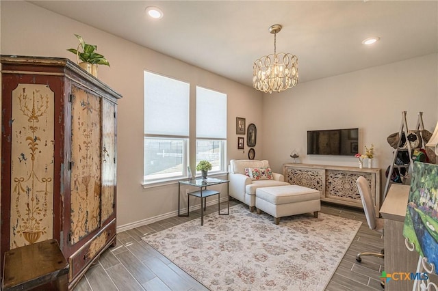 living area featuring a chandelier, wood finished floors, recessed lighting, and baseboards