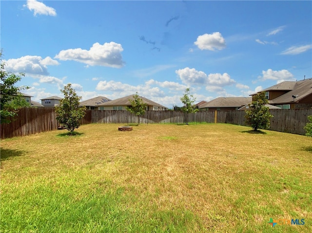 414 Field Corn Ln, San Marcos, TX 78666 - fenced backyard with a residential view and an outdoor fire pit