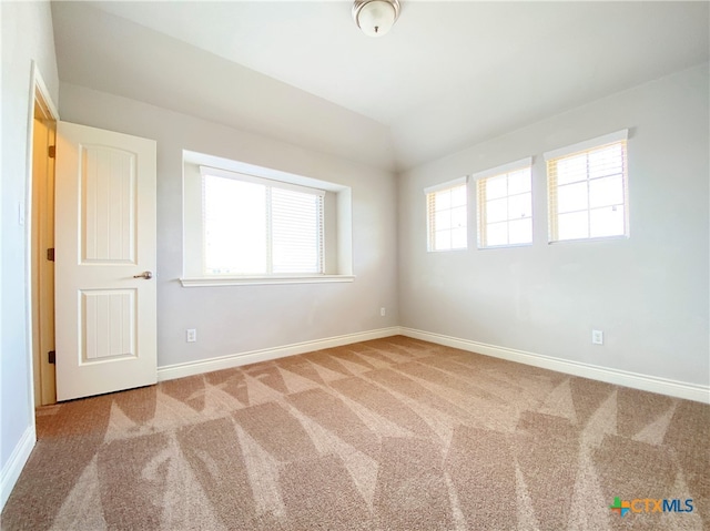 414 Field Corn Ln, San Marcos, TX 78666 - carpeted empty room featuring baseboards and vaulted ceiling