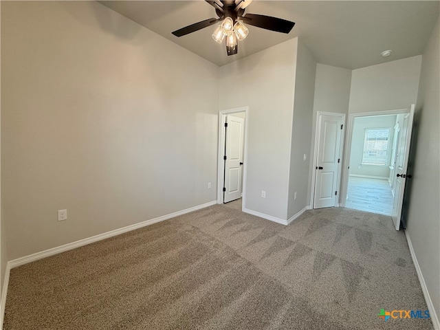 unfurnished bedroom featuring light colored carpet and ceiling fan