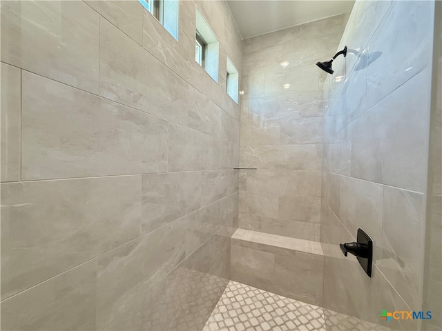 bathroom with a tile shower