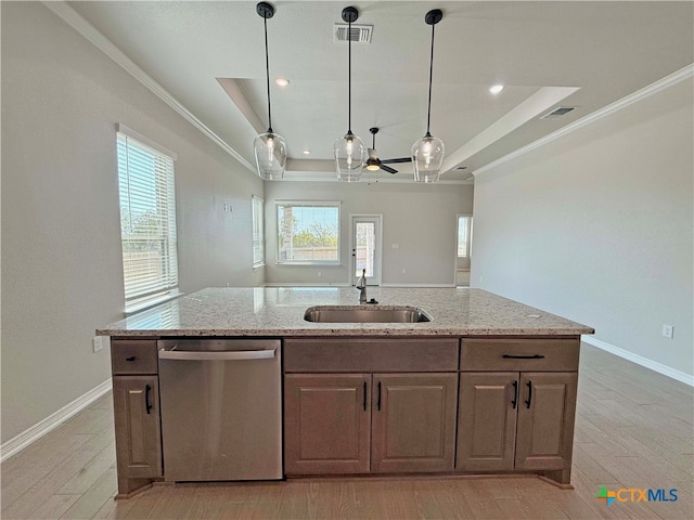 kitchen with a center island with sink, sink, ornamental molding, stainless steel dishwasher, and light wood-type flooring