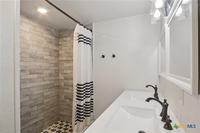 608 E 13th Ave, Belton, TX 76513 - bathroom featuring tiled shower and vanity