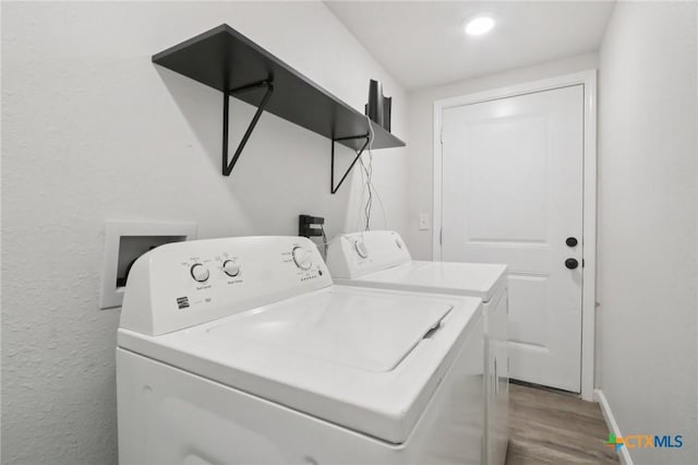 608 E 13th Ave, Belton, TX 76513 - laundry room with washing machine and clothes dryer, wood finished floors, and a textured wall