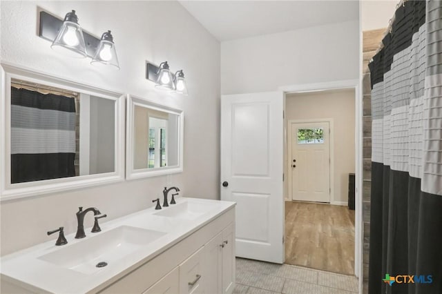 608 E 13th Ave, Belton, TX 76513 - bathroom with double vanity, tile patterned floors, and curtained shower