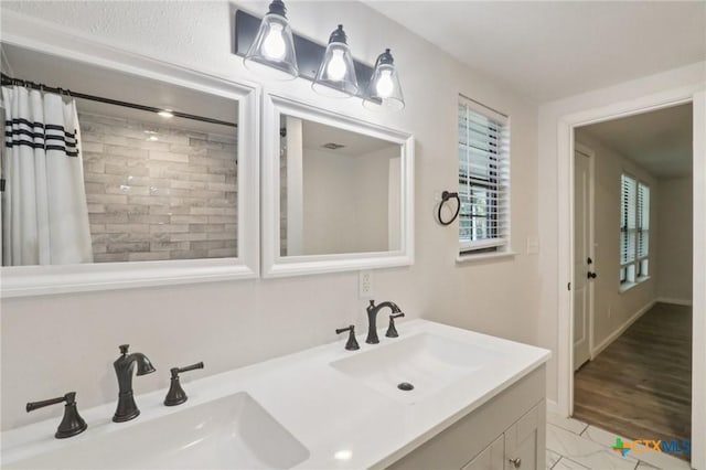 608 E 13th Ave, Belton, TX 76513 - bathroom featuring double vanity and a shower with shower curtain
